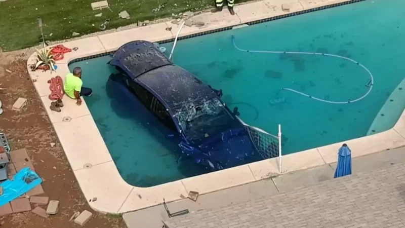 Tesla EV bashes through a wall and plunges into a swimming pool